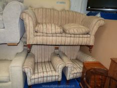 A two seat sofa and two matching armchairs.