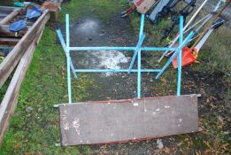 A metal folding saw horse and scaffolding.