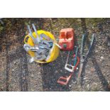 A bucket of joist hangers, garden shears and fuel can.