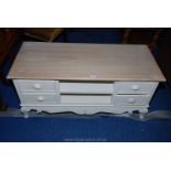 A bleach effect, four drawer TV stand. 47" x 20" x 22" high.