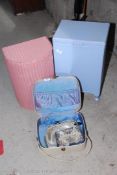 A pink demi loom, Lloyd Loom style, laundry basket, vanity cases and handbags.