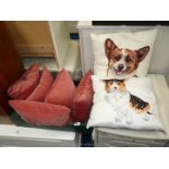 Five pink velour style cushions and two Corgi cushions