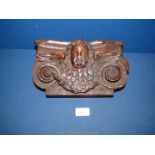 An early Oak Bracket carved with a cherub in high relief.
