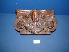 An early Oak Bracket carved with a cherub in high relief.