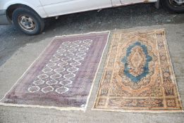 Two bordered patterned and fringed Rugs, one in brown, blue and cream with hexagonal design,