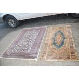 Two bordered patterned and fringed Rugs, one in brown, blue and cream with hexagonal design,