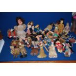 A box of vintage international dolls including interesting examples with bead work, feathers etc.