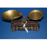 A small cast iron balance scales with ornate moulded base, brass weight tray and bowl.