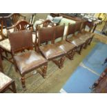 A set of six Oak framed Dining Chairs having turned front legs on sleigh type feet and with Rexene