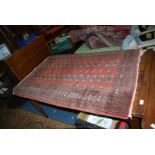 A pink ground bordered, patterned and fringed Rug,