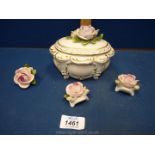 A Rudolstadt Volkstedt porcelain lidded pot and three rose ornaments.