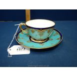 **A 19th century Worcester cup and saucer, painted birds within blue borders.