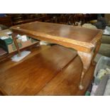 A Walnut and Mahogany coffee Table standing on cabriole legs,