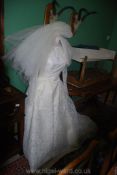 A Vintage lace long sleeve Wedding Dress with train and netted underskirt, back zip opening,