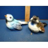 A pair of Goebel birds in blue and brown.