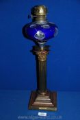 An Oil Lamp with clear glass oil reservoir having white and blue overlay with "cut-out" spot detail,