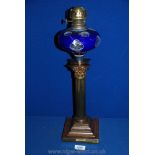 An Oil Lamp with clear glass oil reservoir having white and blue overlay with "cut-out" spot detail,