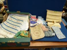 A box of patchwork squares, upholstery edging, etc.