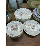 A quantity of Lourioux porcelain decorated with various colourful flowers including tulips, violas,