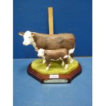 A Naturecraft "Best of Breed" figure Group of polled Hereford Cow and calf, hand-painted in England,