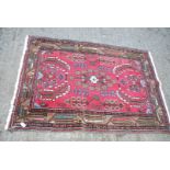 A small bordered patterned and fringed Rug with brown border having stylized flowers, 57" x 40".