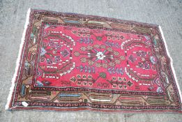 A small bordered patterned and fringed Rug with brown border having stylized flowers, 57" x 40".
