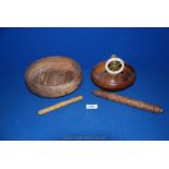 A wooden and brass ship's wheel, nut cracker, a wooden bowl and carved needle cases.