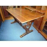 A solid oak refectory table on lyre shaped supports which slot into the top and are held together