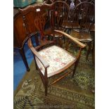 A Mahogany arts and crafts Elbow Chair having slender turned front legs and backrest supports,