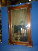 A wooden surround mirror. 37" long x 23" wide.