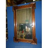 A wooden surround mirror. 37" long x 23" wide.