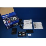 An Olympus FE-290 7.1 Mega Pixel Digital Camera in original box with battery and charger.