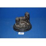 A cast sculpture on black marble base of two long haired Yorkie type dogs, indistinctly signed,