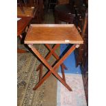 A rectangular Oak Tray having turned handles with brass fittings 23 1/2'' x 17 1/8'' and a folding