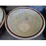 A large slip glazed dairy bowl 16" diameter x 7" tall and a medium slip glazed dairy bowl 13 3/4"