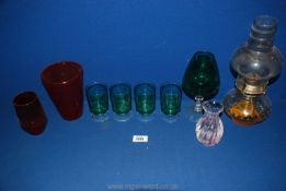 A quantity of glass to include oil lamp, four green glasses, red vases, etc.