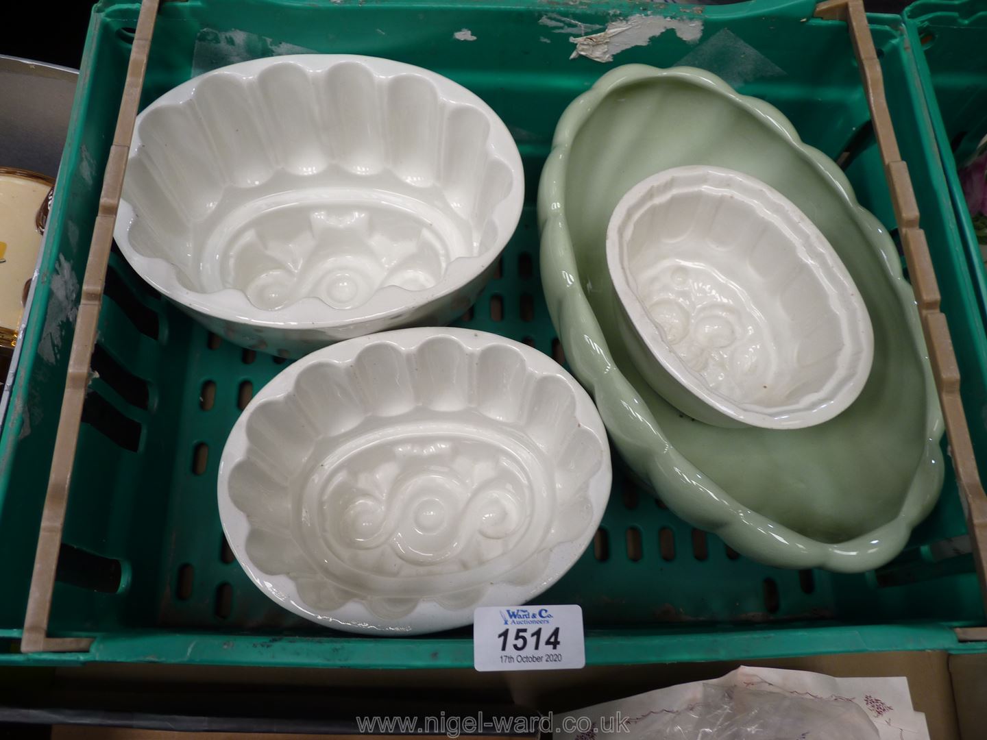 Three jelly moulds and a Beswick vase.