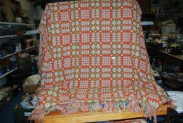 A Welsh blanket in orange and green, double size.