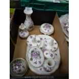 A china dressing table set, white ground decorated with violets including tray, two ring holders,