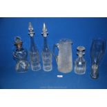 A quantity of glassware including a pair of grapevine etched decanters (one stopper a/f.