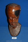 A carved African bust of a gent,