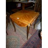 A continental mixed woods quarter-veneered occasional Table standing on cabriole legs with ormolu