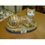 A Staffordshire style model of a cat with a ball at her feet, 9" long x 5 1/2" tall.