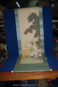 A Japanese hanging scroll of two soldiers, one with a baby. 180cm x 55cm.