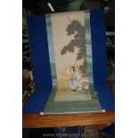 A Japanese hanging scroll of two soldiers, one with a baby. 180cm x 55cm.