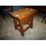 An Oak drop-leaf gateleg occasional Table standing on twist legs,