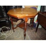 An Edwardian Mahogany octagonal occasional Table standing on turned legs and with a lower galleried