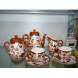 An Oriental coffee/tea set with swallows and flowers.