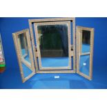 A triple, free standing dressing table Mirror having hinged central mirror,