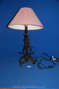 A metal table Lamp in the form of antlers, 18'' tall plus maroon shade.